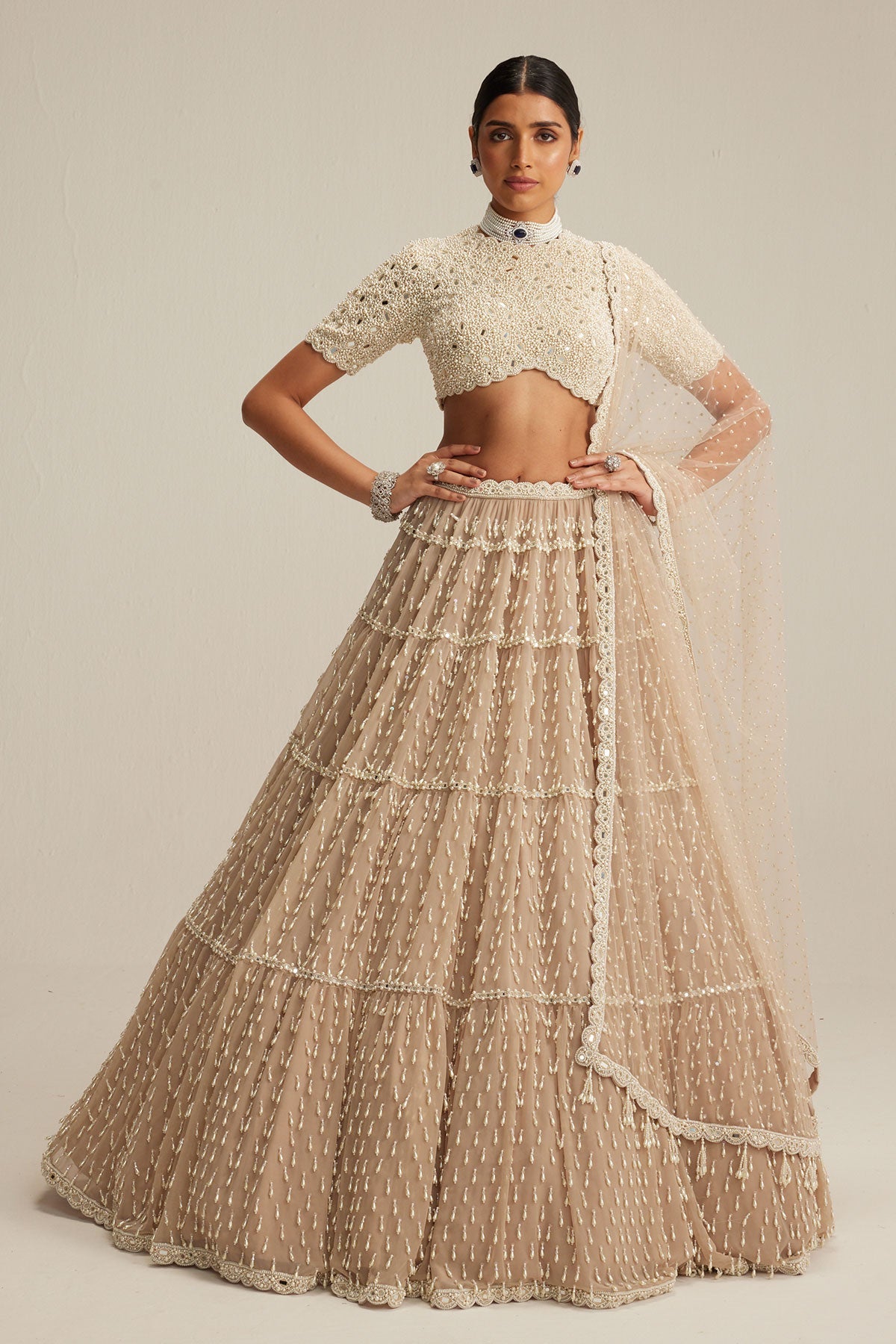 Light Beige Pearl Drop Multi Tier Lehenga With High Neck Blouse Set.