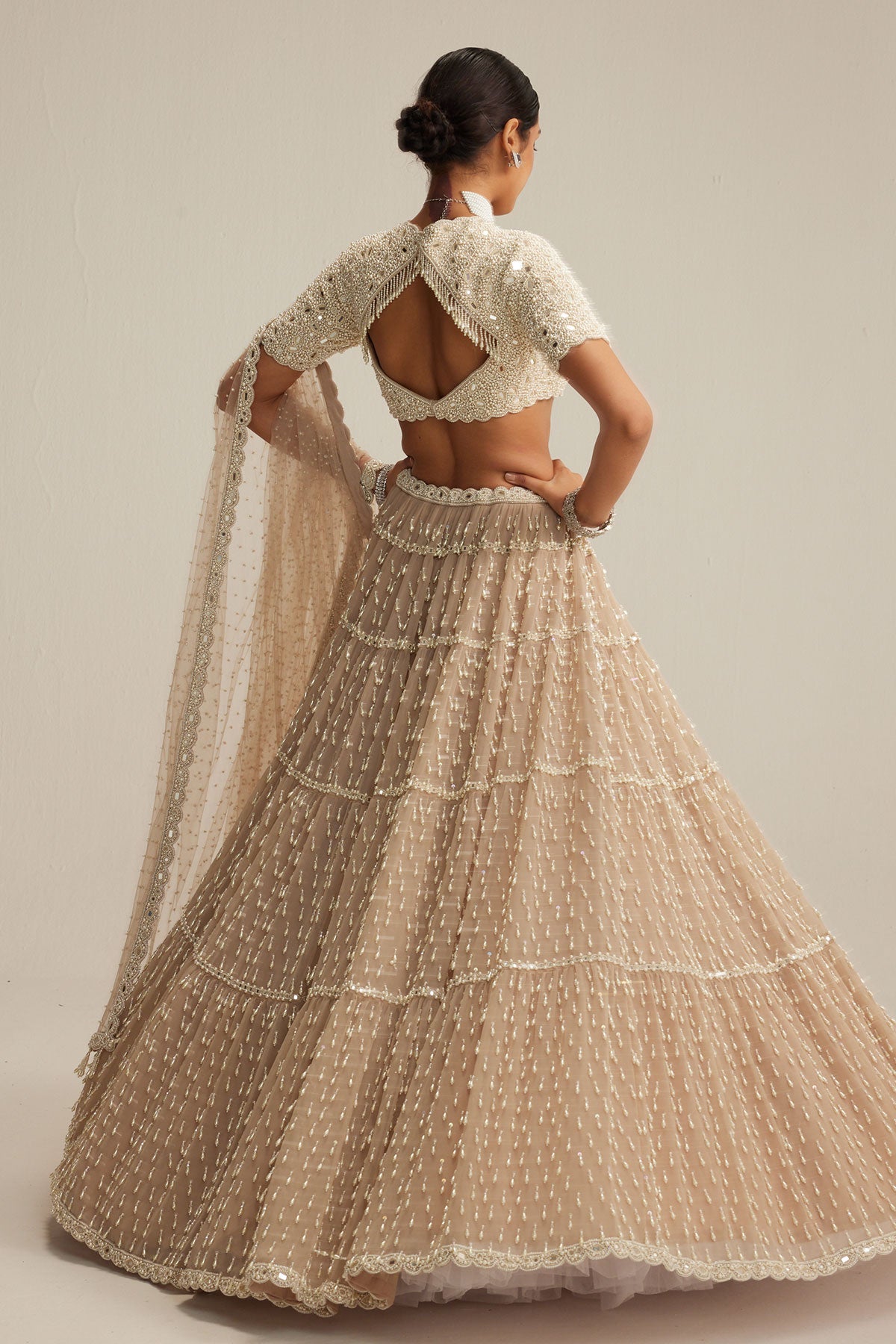 Light Beige Pearl Drop Multi Tier Lehenga With High Neck Blouse Set.
