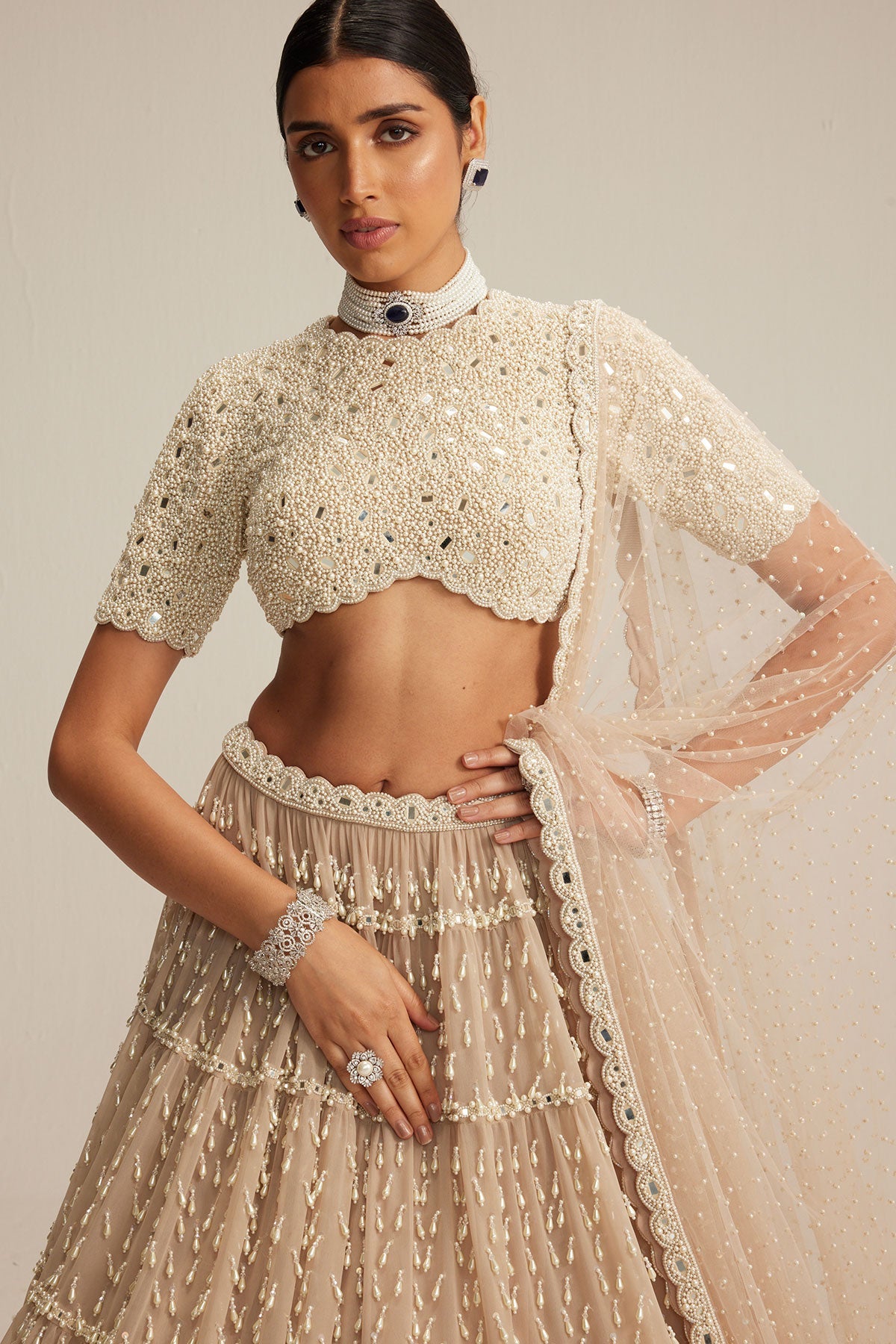 Light Beige Pearl Drop Multi Tier Lehenga With High Neck Blouse Set.