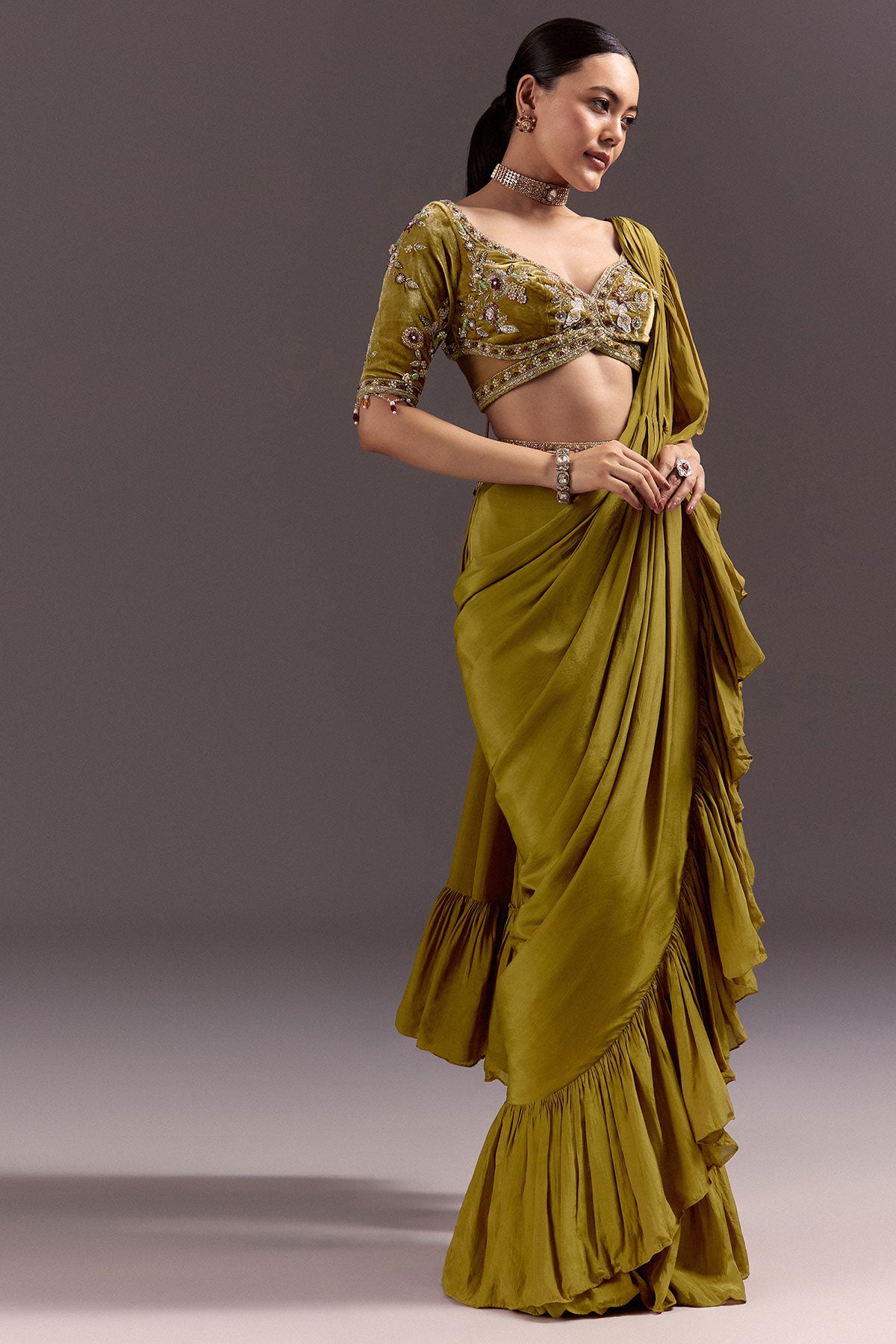 Olive Green Velvet Saree With Frilled Pallu And Heavy Embroidered Blouse