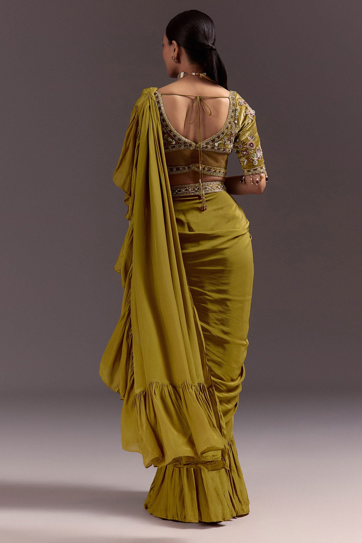 Olive Green Velvet Saree With Frilled Pallu And Heavy Embroidered Blouse