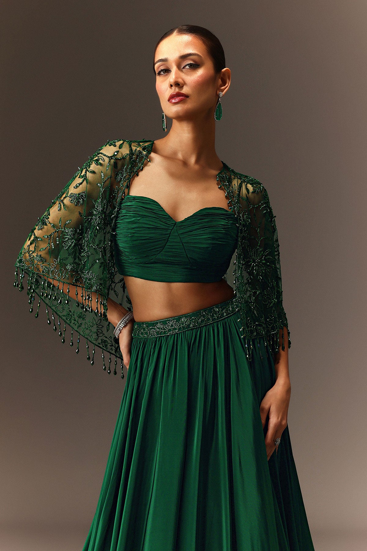 Bottle Green Tiered Lehenga With Net Cape