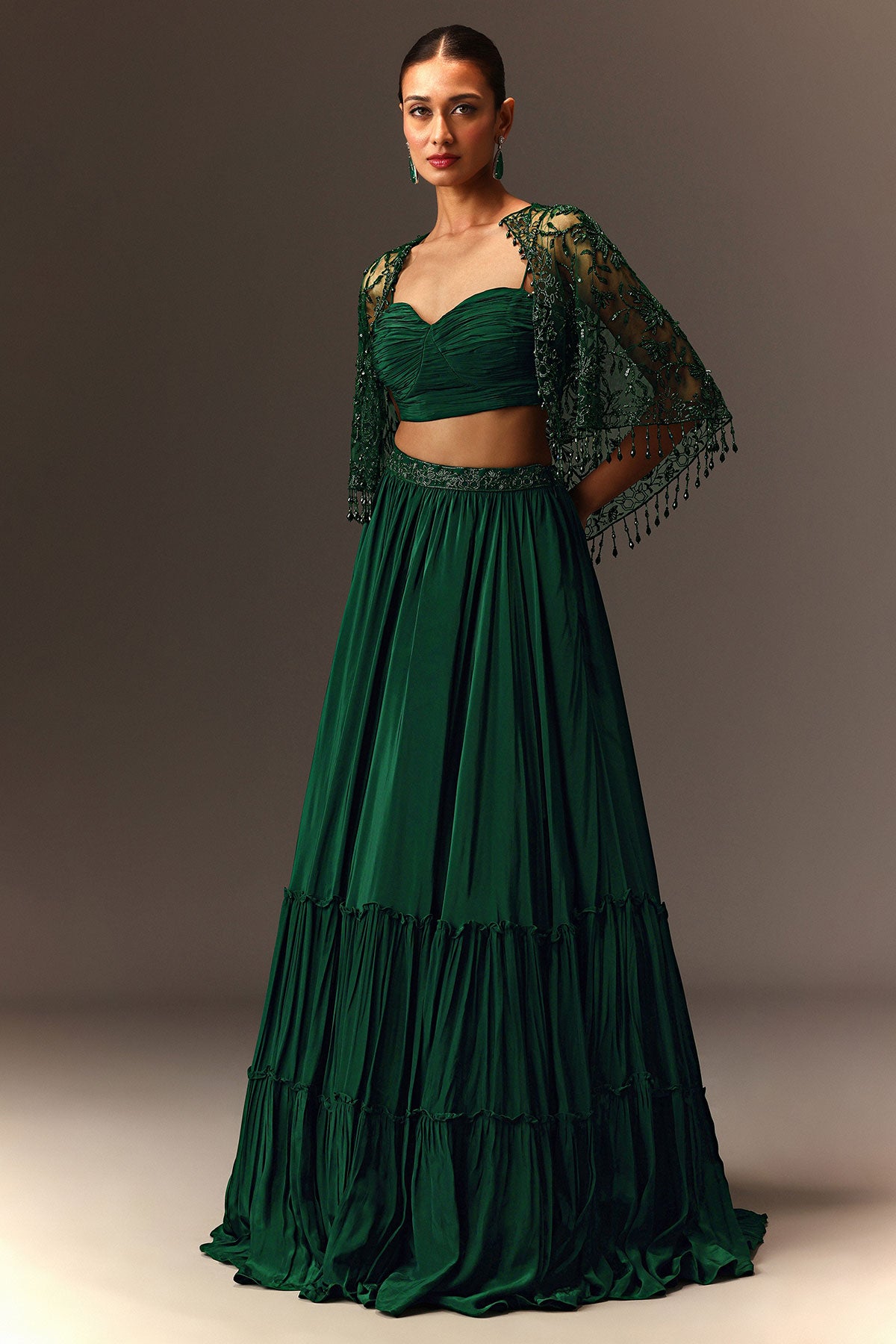 Bottle Green Tiered Lehenga With Net Cape