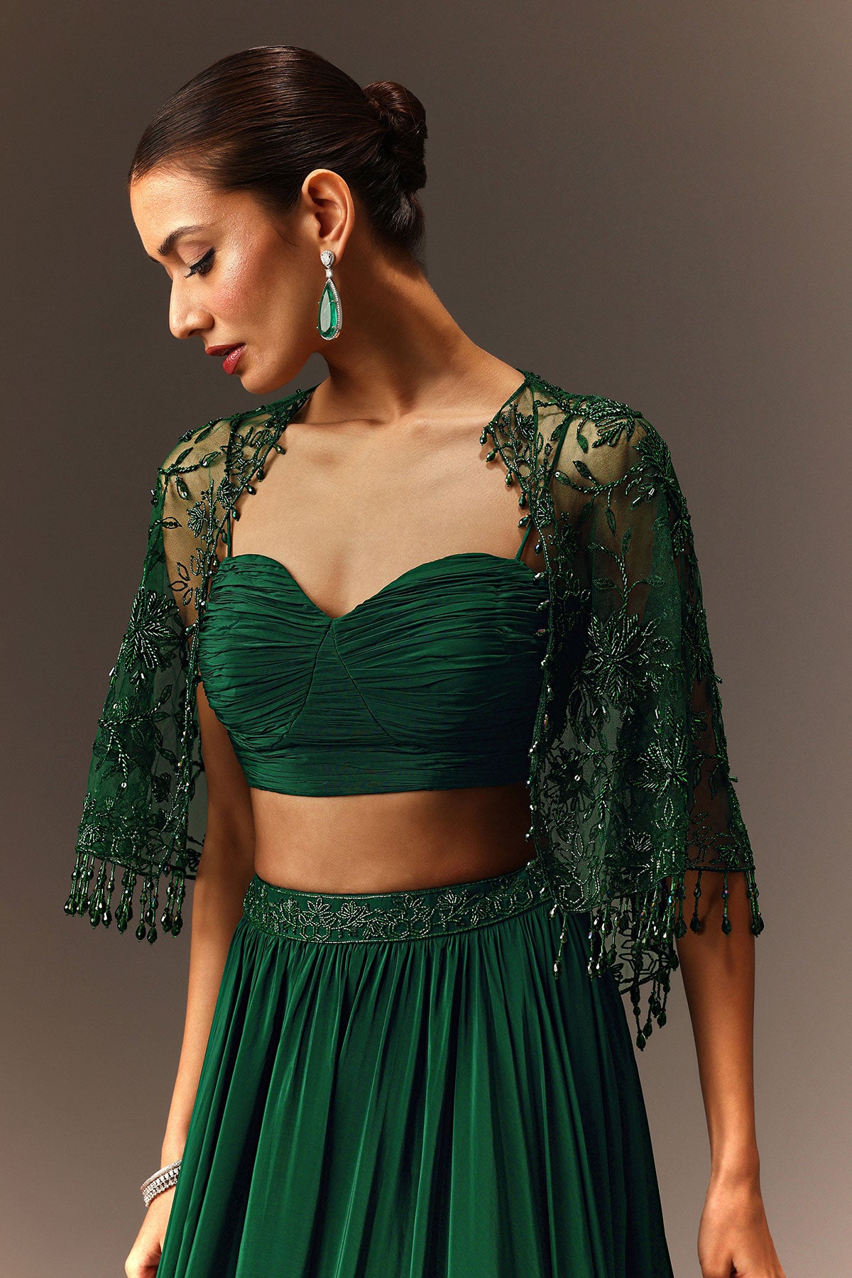 Bottle Green Tiered Lehenga With Net Cape