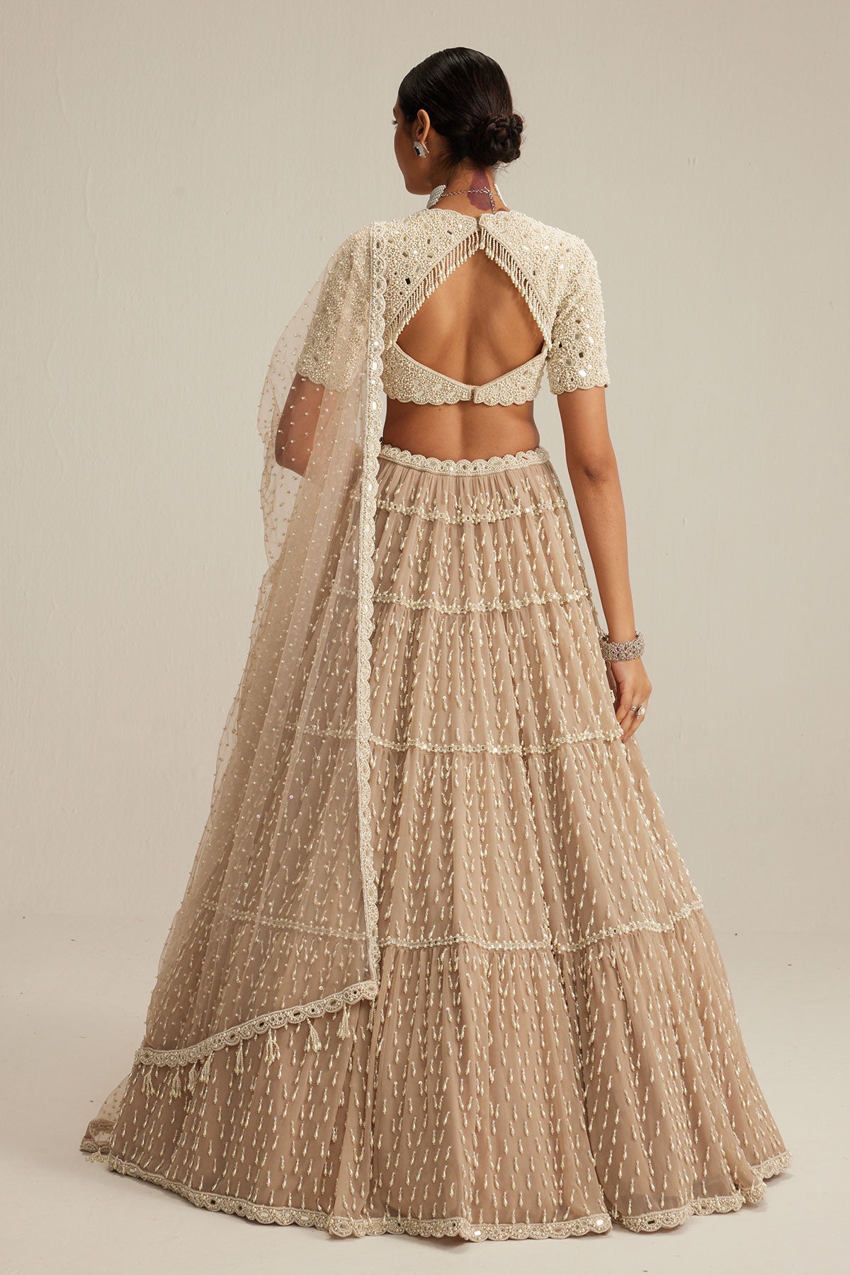 Light Beige Pearl Drop Multi Tier Lehenga With High Neck Blouse Set.