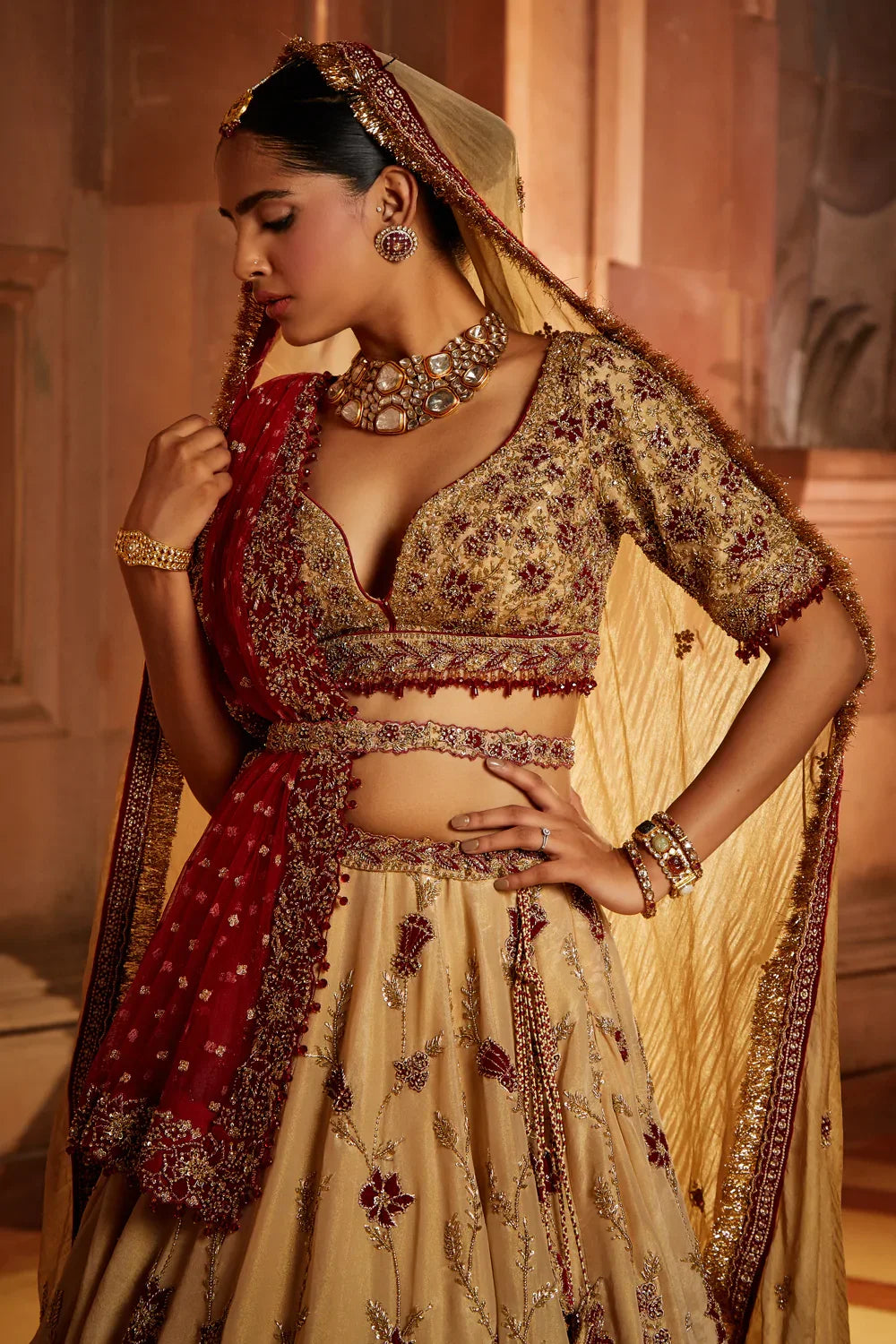 GOLD TISSUE LEHENGA CHOLI AND BELT WITH CONTRASTING RED TULLE DUPATTA