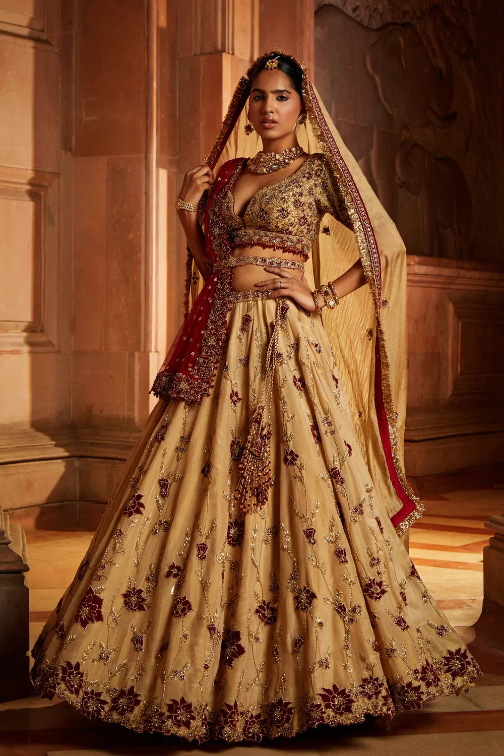 GOLD TISSUE LEHENGA CHOLI AND BELT WITH CONTRASTING RED TULLE DUPATTA