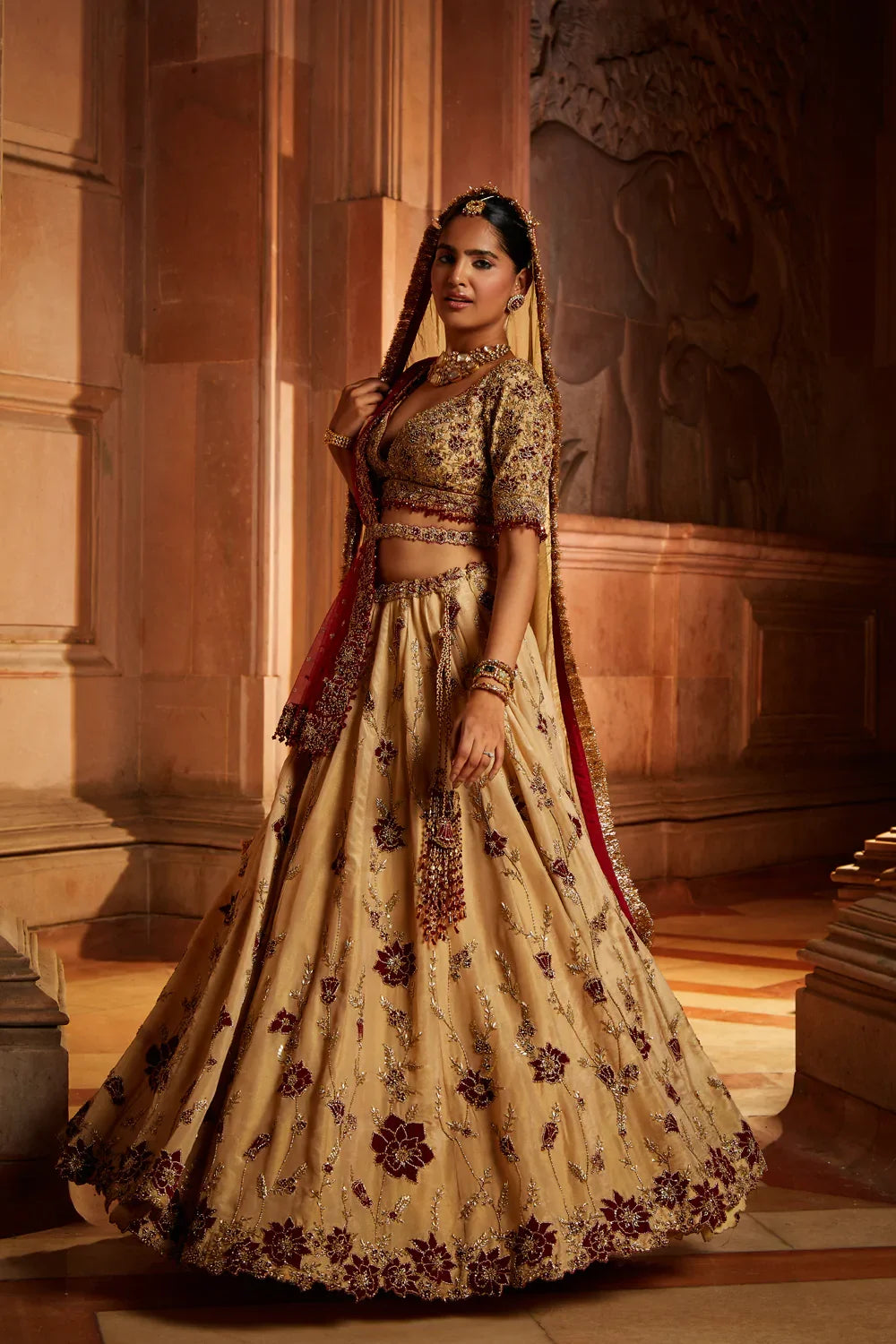 GOLD TISSUE LEHENGA CHOLI AND BELT WITH CONTRASTING RED TULLE DUPATTA