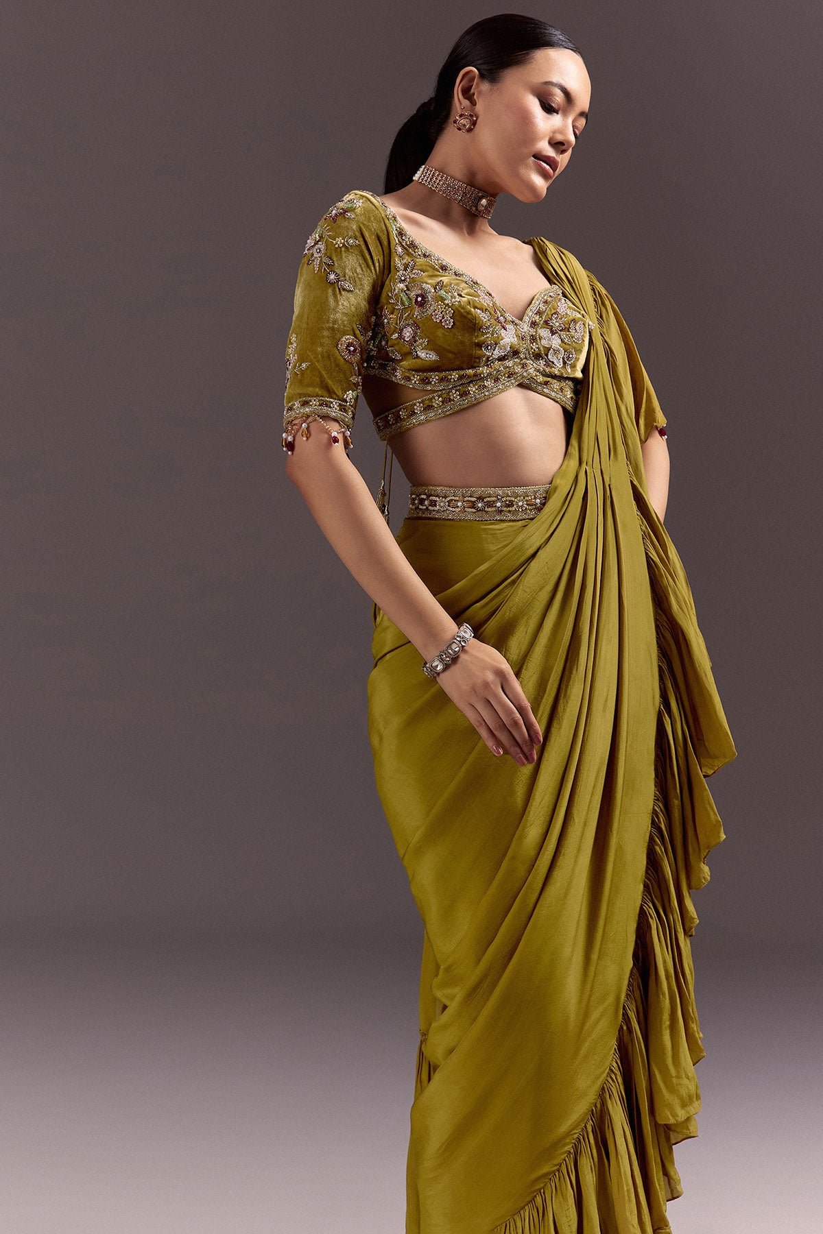 Olive Green Velvet Saree With Frilled Pallu And Heavy Embroidered Blouse