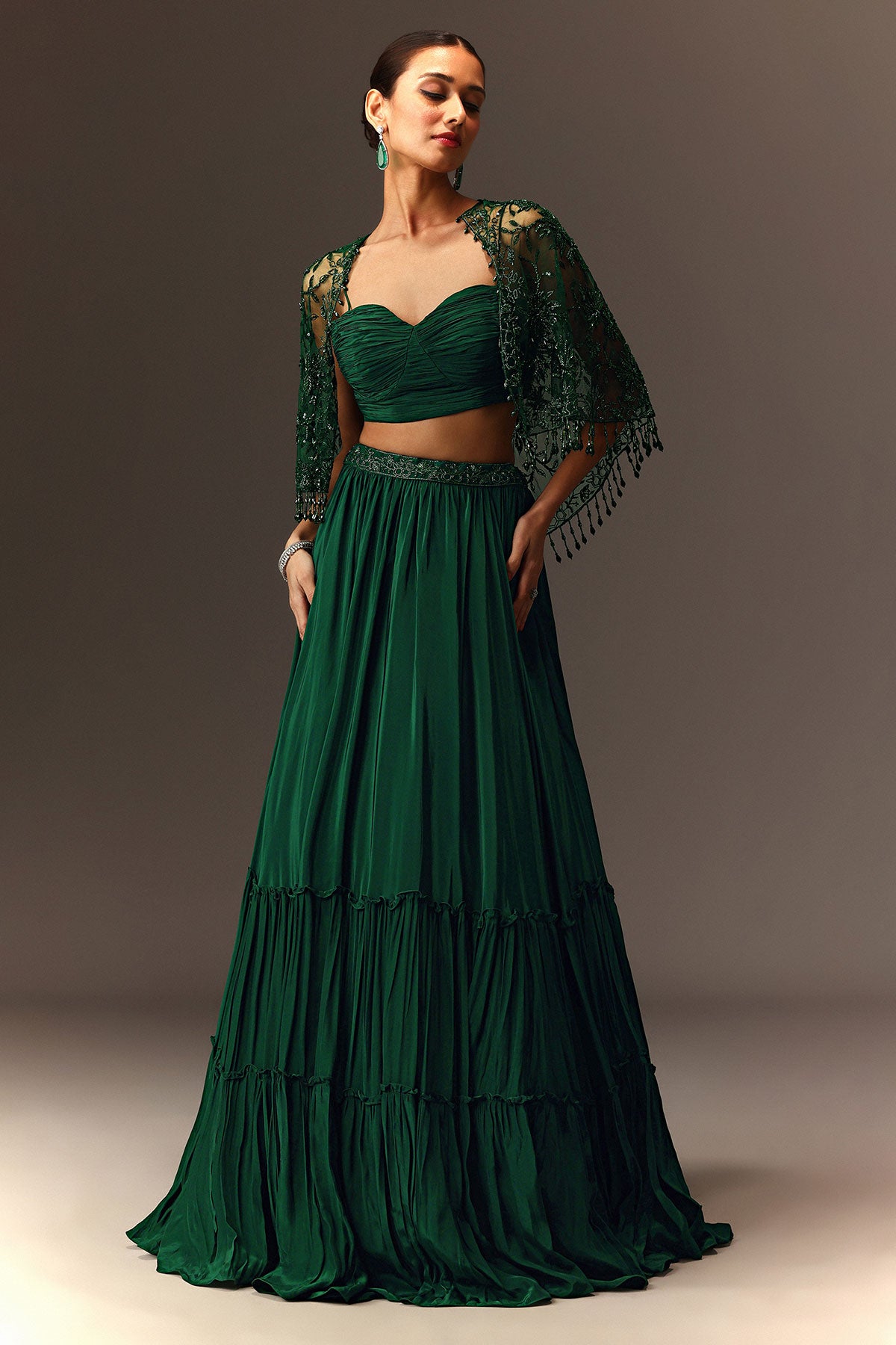 Bottle Green Tiered Lehenga With Net Cape