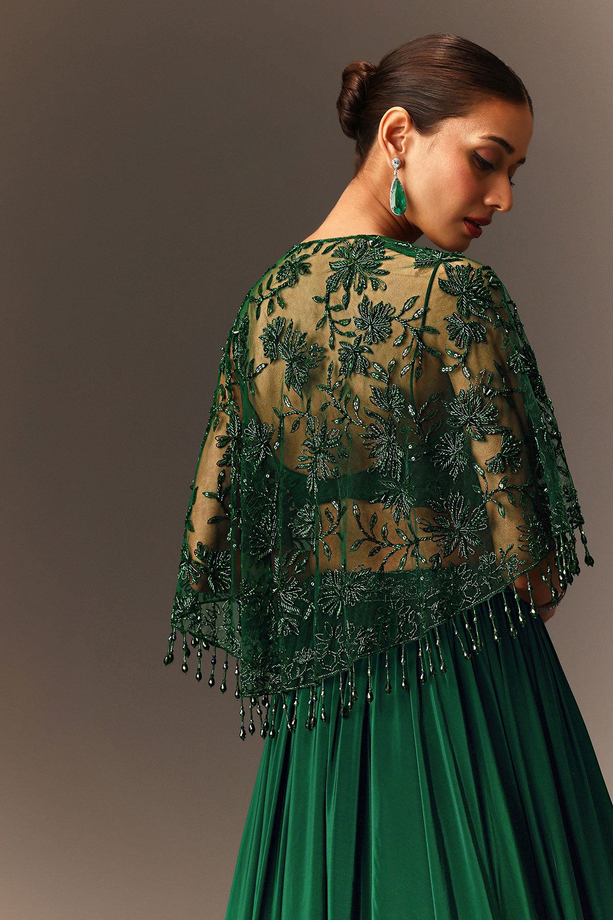 Bottle Green Tiered Lehenga With Net Cape